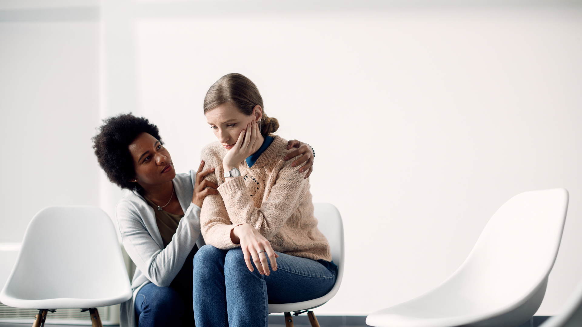 caring-african-american-woman-consoling-sad-woman-before-group-therapy-meeting - Mental Health Counseling