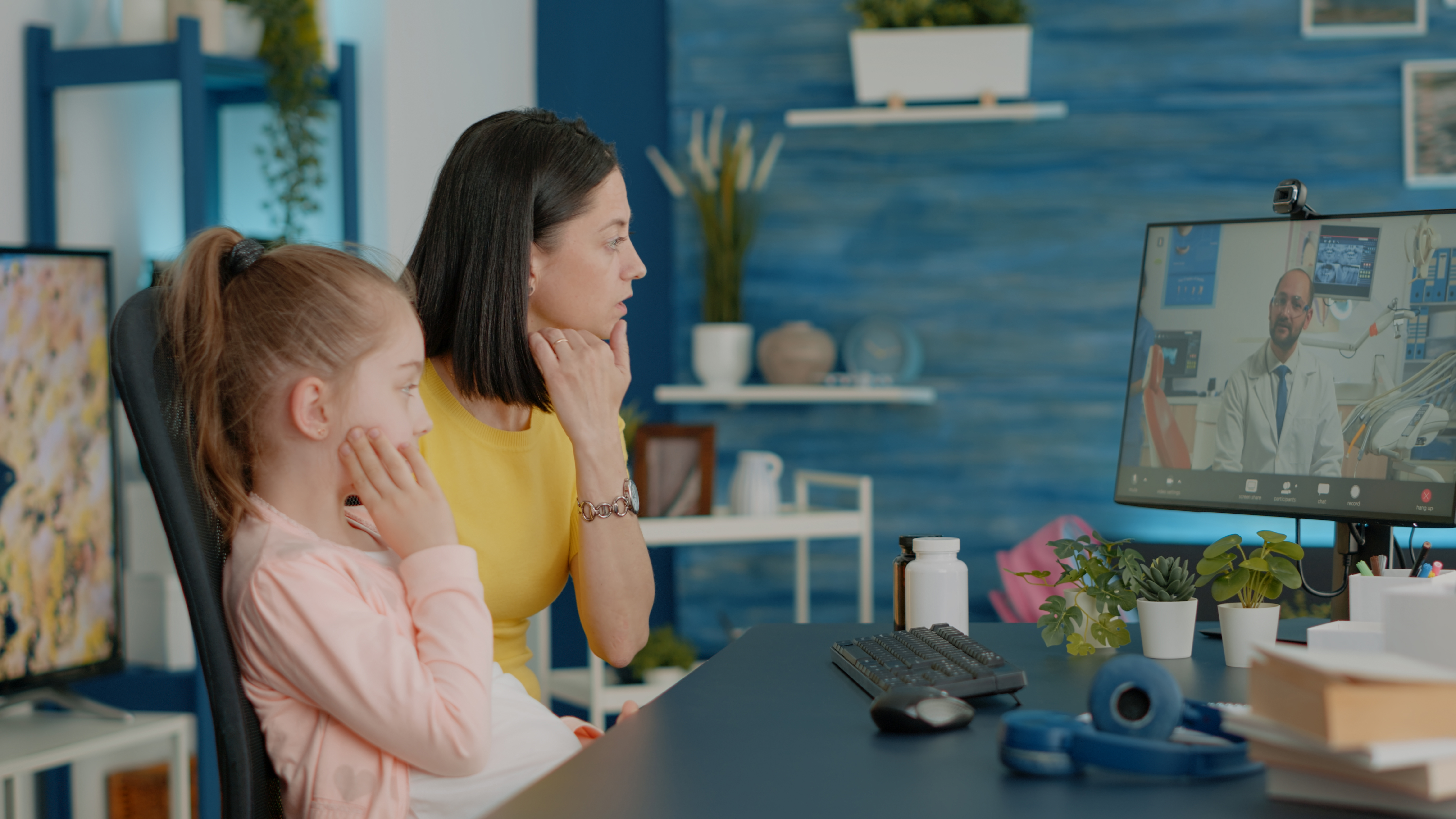 Mother of girl with toothache talking to dentist on video call